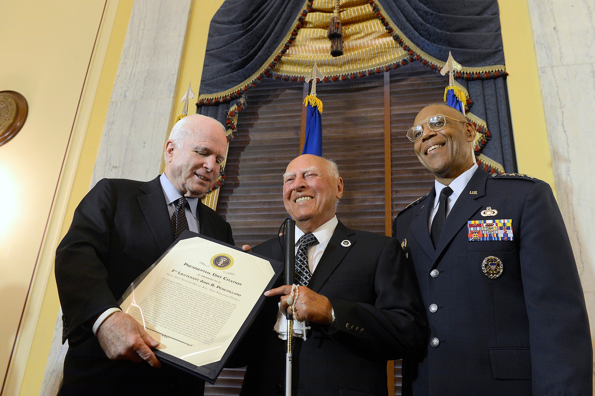 Sen. John McCain and Air Force Vice Chief of Staff Gen. Larry O. Spencer congratulate 2nd Lt. John Pedevillano, a WWII Army Air Corps B-17 bombardier, during a ceremony in his honor, in Washington, D.C., July 7, 2015. McCain and Spencer presented Pedevillano with the Presidential Unit Citation with one oak leaf cluster. He is the last survivor of his WWII unit. (U.S. Air Force photo/Scott M. Ash)