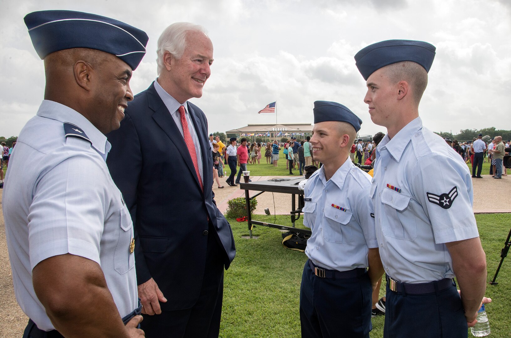 U.S. Sen. John Cornyn and Brig. Gen. Trent Edwards, 37th Training Wing commander, visit with recent graduates Airman 1st Class Timothy Stewart and Airman Chase Floyd after the Air Force Basic Military Training graduation parade July 3 at the parade grounds at Joint Base San Antonio-Lackland. The senator visited JBSA-Lackland to learn about the function and mission of the 37th Training Wing, the largest training wing in the Air Force, and to thank the newest members of the U.S. Air Force for their commitment and service. 