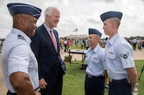 U.S. Sen. John Cornyn and Brig. Gen. Trent Edwards, 37th Training Wing commander, visit with recent graduates Airman 1st Class Timothy Stewart and Airman Chase Floyd after the Air Force Basic Military Training graduation parade July 3 at the parade grounds at Joint Base San Antonio-Lackland. The senator visited JBSA-Lackland to learn about the function and mission of the 37th Training Wing, the largest training wing in the Air Force, and to thank the newest members of the U.S. Air Force for their commitment and service. 