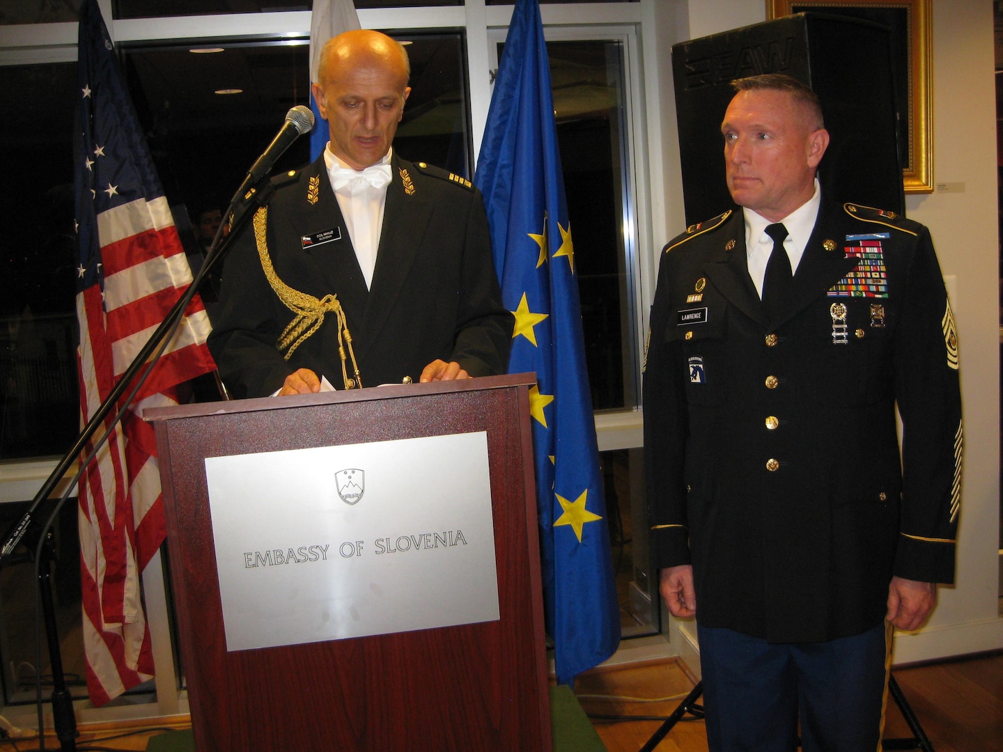 Slovenian Defense Attache Col.  Ivan Mikuz awards Colorado National Guard Senior Enlisted Leader Command Sgt. Maj. Michael R. Lawrence the medal for multinational cooperation at the Embassy of the Republic of Slovenia June 23, 2015.  Lawrence has spent two decades helping build the partnership between Slovenia and Colorado as part of the National Guard State Partnership Program. 
