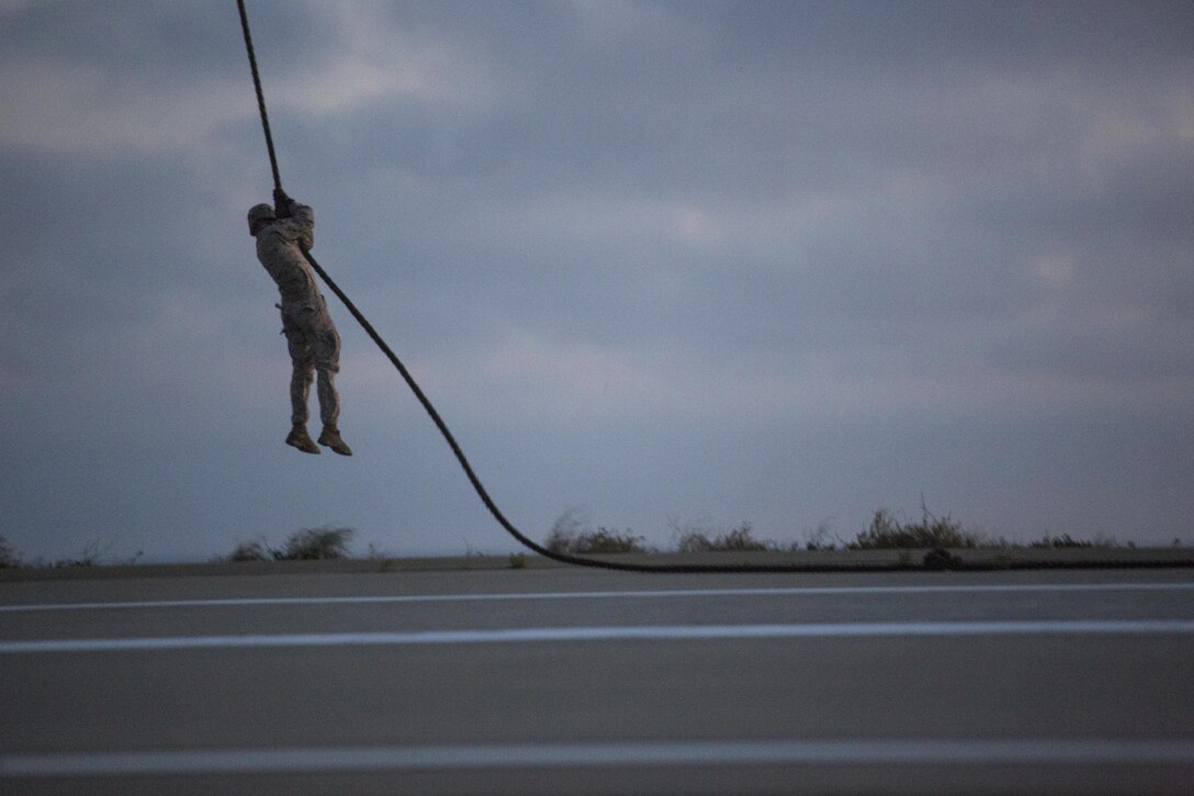 An infantry Marine from Golf Company, Battalion Landing Team 2nd Battalion, 1st Marine Regiment fast ropes from a CH-53E Super Stallion on Marine Corps Base Camp Pendleton, California, July 2. The helicopter pilots maintained a steady hover over the landing area as infantry Marines fast roped from a trap door in the bottom of the aircraft. (U.S. Marine Corps photo by Sgt. Lillian Stephens/Released)