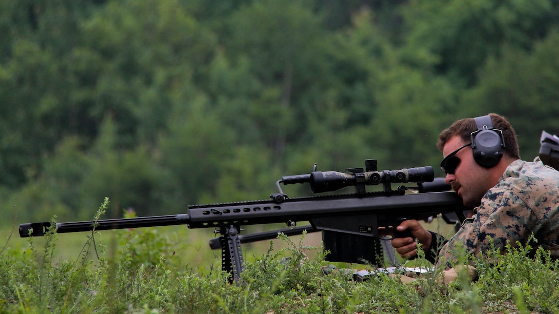 scout sniper student, fires a .50 caliber M107 special application scoped rifle during scout sniper training, July 2. The Scout Sniper Instructor School is part of the Weapon’s Training Battalion aboard Marine Corps Base Quantico.