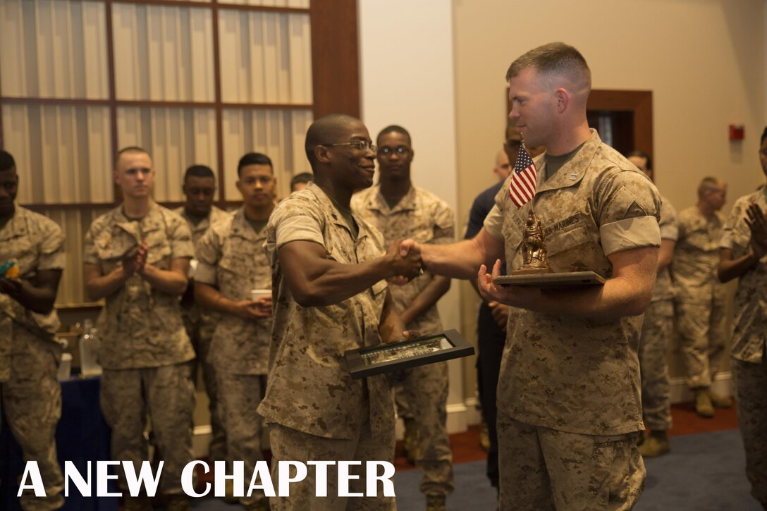 Capt. John Ed Auer revieves a commemorative plaque after the Change of Command ceremony for  Headquarters and Service Company, Marine Barracks Washington, D.C., inside Crawford Hall, July 8, 2015. (U.S. Marine Corps photo by Cpl. Chi Nguyen/Released)