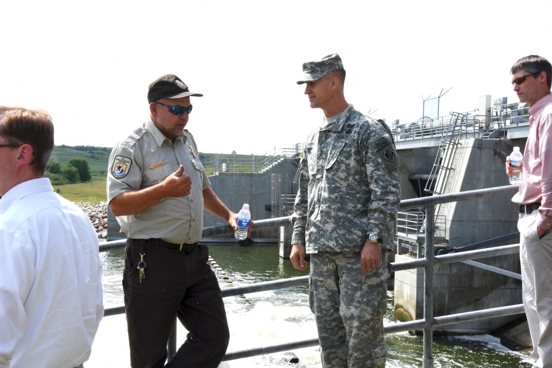 Tom Pabian, U.S. Fish and Wildlife Service and Lake Darling Operations Manager, briefs Maj. Gen. Michael Wehr, Mississippi Valley Division commander, on the dam’s operation, during the commander’s recent visit to North Dakota on July 6. Lake Darling is approximately 30 miles upstream of Minot, N.D.