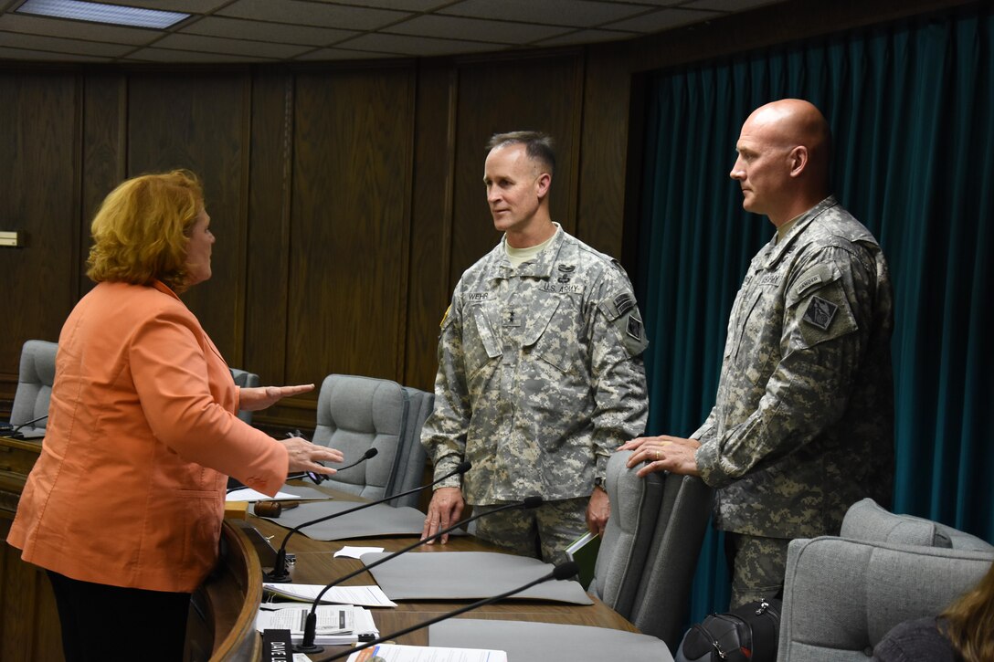U.S. Sen. Heidi Heitkamp talks with Mississippi Valley Division Commander Maj. Gen. Michael Wehr, center, and St. Paul District Commander Col. Dan Koprowski following a stakeholder meeting at Minot City Hall July 6, 2015. This is Maj. Gen. Wehr's first trip to see areas damaged in Minot and Ward County, N.D., during the 2011 flood.