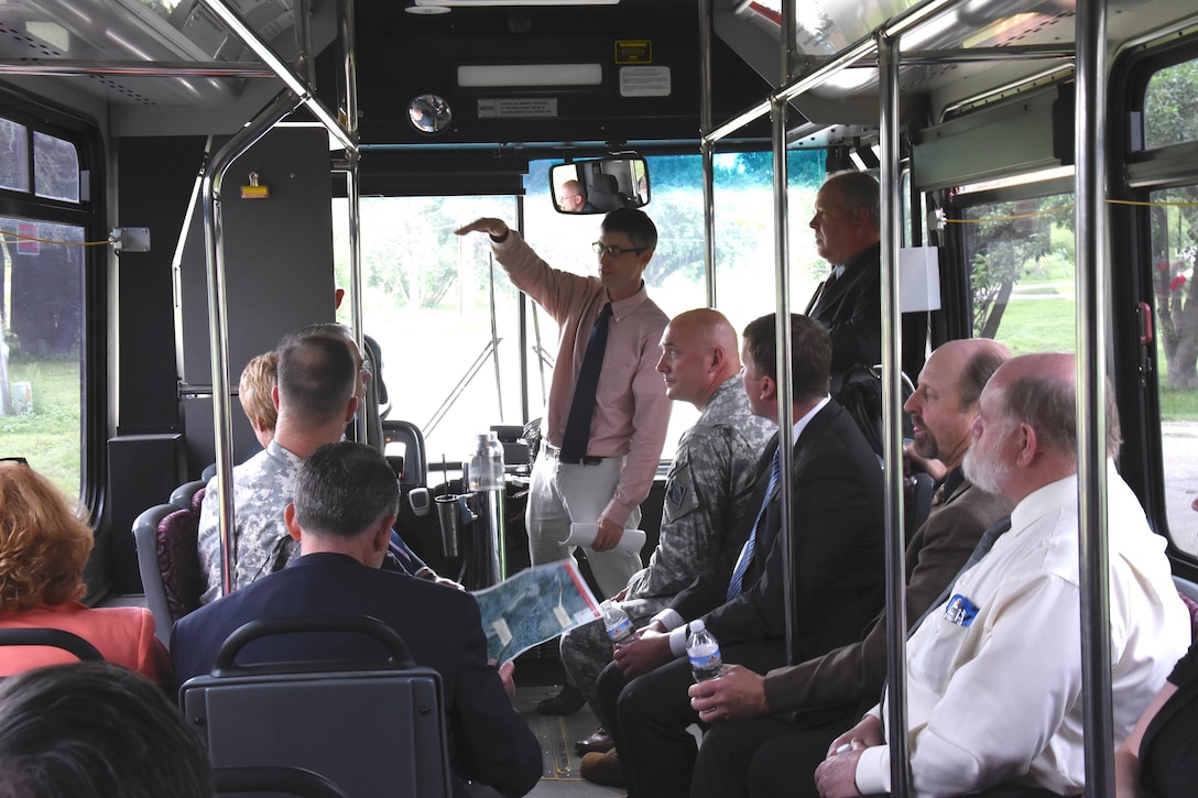 Nathan Wallerstedt, St. Paul District project manager for Minot, N.D., area projects, points out items of interest to Mississippi Valley Division Commander Maj. Gen. Michael Wehr and stakeholders during a bus tour following the stakeholder meeting on July 6. This is Maj. Gen. Wehr's first trip to see areas damaged in Minot and Ward County, N.D., during the 2011 flood.