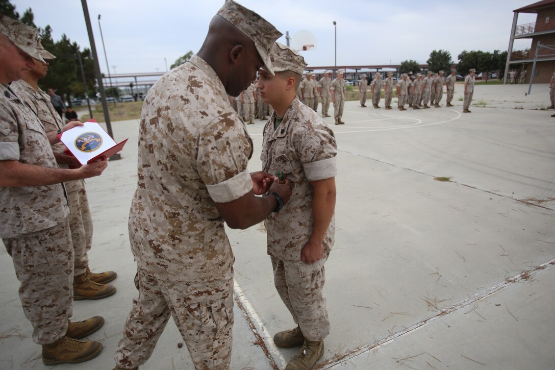 Marines with the 13th Marine Expeditionary Unit are presented with awards and promoted aboard Marine Corps Base Camp Pendleton, Calif., July 1, 2015. While some Marines are awarded for their expertise in their field and creative ideas, while others were promoted receiving even greater responsibilities.(U.S. Marine Corps photo by Lance Cpl. Alvin Pujols/Released) 