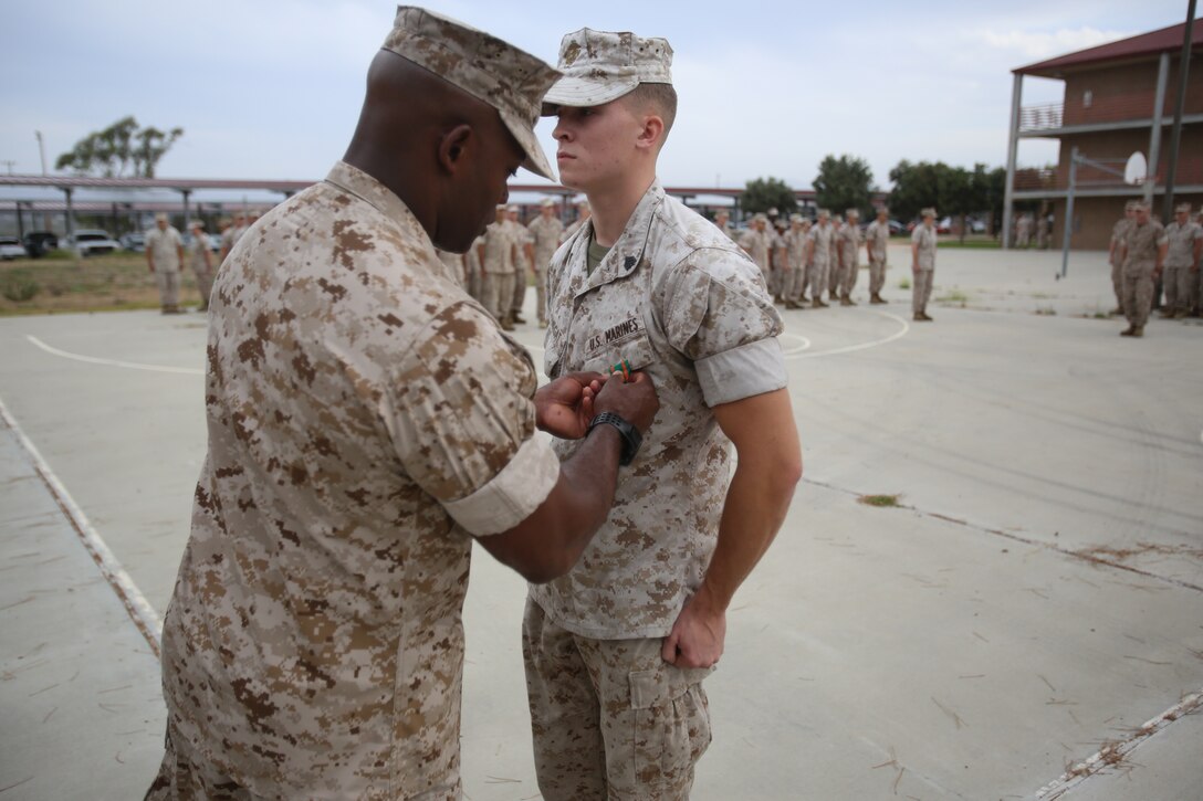 Marines with the 13th Marine Expeditionary Unit are presented with awards and promoted aboard Marine Corps Base Camp Pendleton, Calif., July 1, 2015. While some Marines are awarded for their expertise in their field and creative ideas, while others were promoted receiving even greater responsibilities.(U.S. Marine Corps photo by Lance Cpl. Alvin Pujols/Released) 