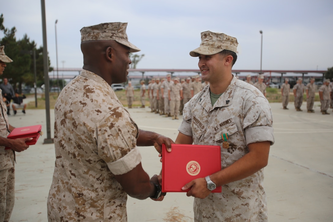 Marines with the 13th Marine Expeditionary Unit are presented with awards and promoted aboard Marine Corps Base Camp Pendleton, Calif., July 1, 2015. While some Marines are awarded for their expertise in their field and creative ideas, while others were promoted receiving even greater responsibilities.(U.S. Marine Corps photo by Lance Cpl. Alvin Pujols/Released) 