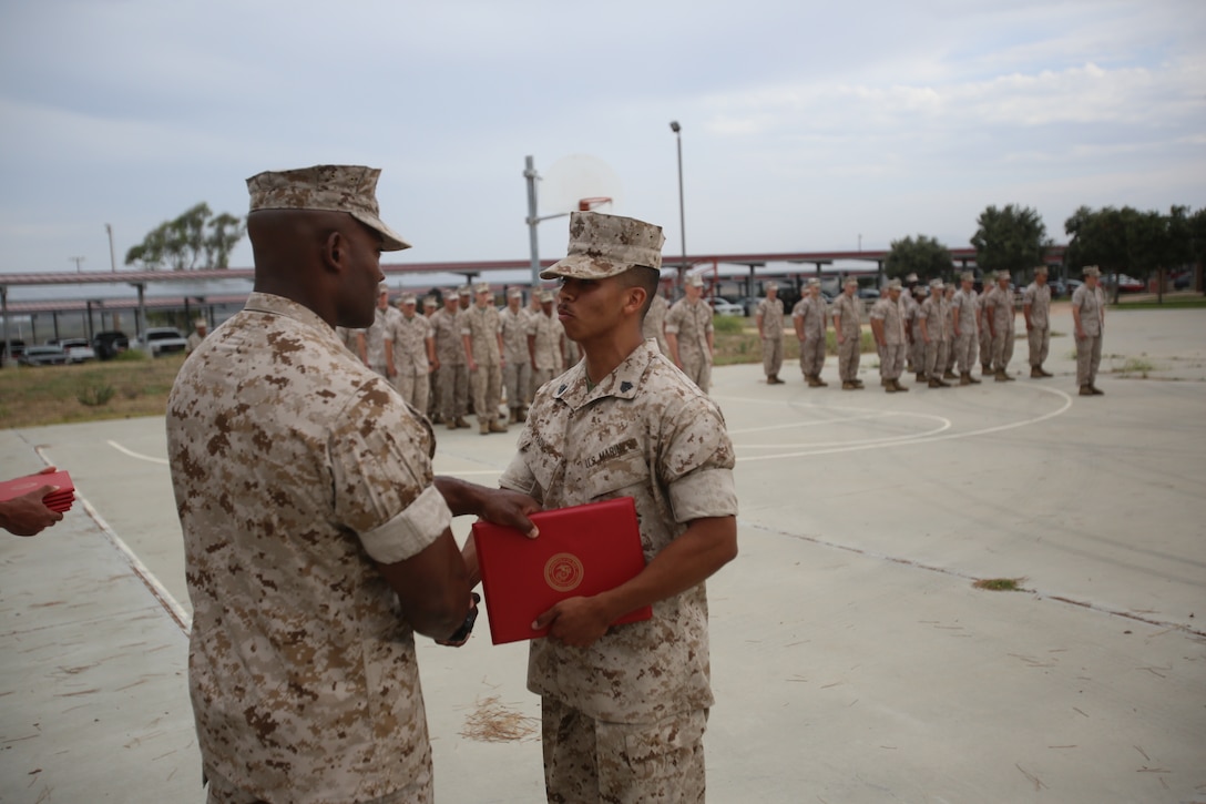 Marines with the 13th Marine Expeditionary Unit are presented with awards and promoted aboard Marine Corps Base Camp Pendleton, Calif., July 1, 2015. While some Marines are awarded for their expertise in their field and creative ideas, while others were promoted receiving even greater responsibilities.(U.S. Marine Corps photo by Lance Cpl. Alvin Pujols/Released) 