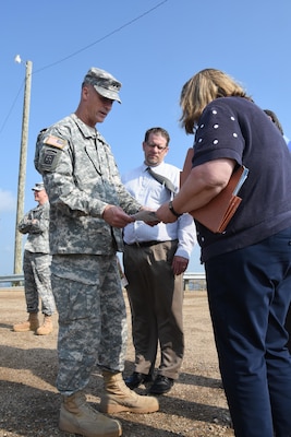 Bonnie Greenleaf, Devils Lake flood risk management project manager, briefs Mississippi Valley Division commander Maj. Gen. Michael Wehr on features of the project during a tour of the area during his North Dakota visit July 6-8, 2015. The Devils Lake basin is a 3,810 square-mile sub-basin of the Red River of the North with no natural outlet until lake levels reach an elevation 1,458, at which it flows through Tolna Coulee into the Sheyenne River. Maj. Gen. Wehr received an orientation of the Devils Lake Basin prior to attending Devils Lake Executive Committee, or DLEC, meeting July 8, 2015. The DLEC, co-chaired by the commander of the Mississippi Valley Division and the governor of North Dakota,  is comprised of representatives from more than 20 Federal, State, tribal, local agencies and governmental entities.