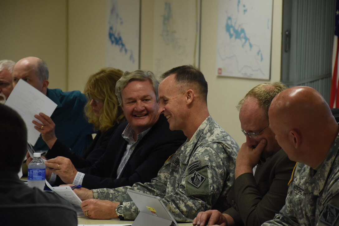 North Dakota Gov. Jack Dalrymple talks with Maj. Gen. Michael Wehr prior to the start of the Devils Lake Executive Committee, or DLEC, meeting July 8, 2015. The DLEC, co-chaired by the commander of the Mississippi Valley Division and the governor of North Dakota,  is comprised of representatives from more than 20 Federal, State, tribal, local agencies and governmental entities.