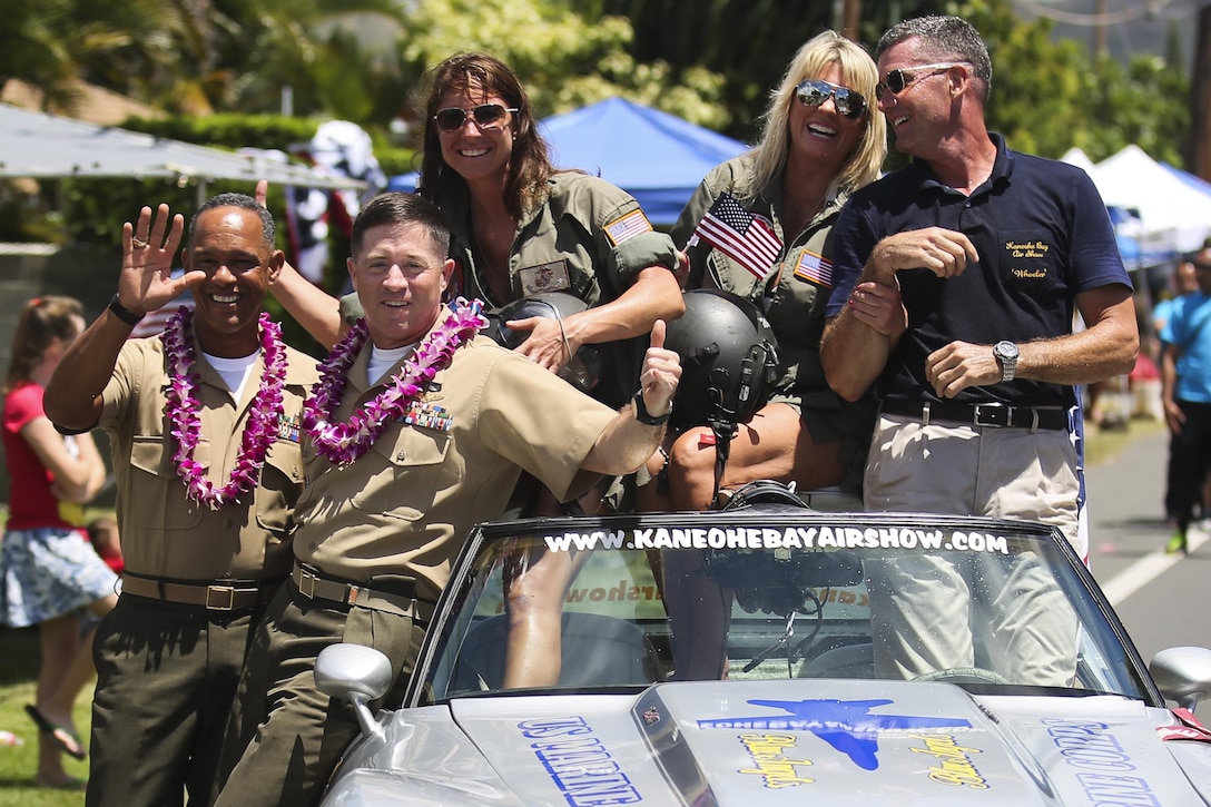 (From left to right) Sgt. Maj. Gregory L. Hall, the base sergeant major for Marine Corps Base Hawaii; Col. Sean C. Killeen, the commanding officer of MCB Hawaii; Bobbie Brock and Tammy Clifton, members of the Kaneohe Bay Air Show promotion crew; and Pete O’hare, the air show director, pose for a photo during the 69th Annual Kailua Independence Day Parade, July 4, 2015. The parade includes local politicians and dignitaries, military and veteran units, community and federal groups, as well as bands, including the Royal Hawaiian Band and the Kukui High School Alumni Marching Band. The parade provided an opportunity for people to celebrate Independence Day and show their support for the local community. (U.S. Marine Corps photo by Lance Cpl. Harley Thomas/Released)