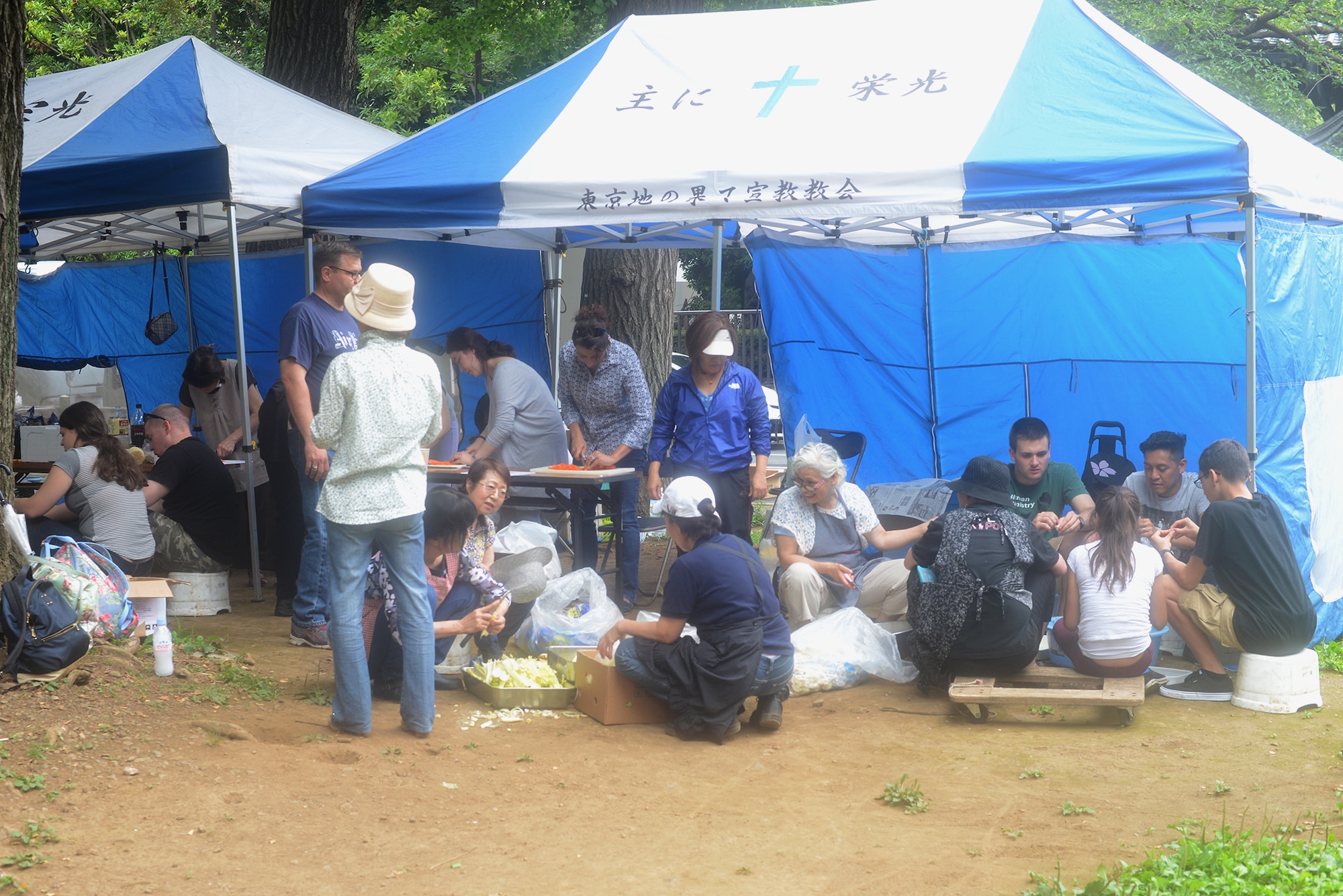 Members from Yokota Air Base and members of a local church prepare food for the homeless, at Ueno Park, Tokyo Japan, June 26, 2015. The Homeless Ministry holds three to four outreach events weekly with Team Yokota members supporting one per month. (U.S. Air Force photo by Airman 1st Class David C. Danford/Released)