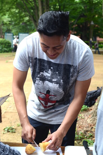 Mark Dacumos slices potatoes used to feed homeless men and women at Ueno Park, Tokyo Japan, June 26, 2015. More than 400 people were fed during the homeless outreach event. (U.S. Air Force photo by Airman 1st Class David C. Danford/Released)