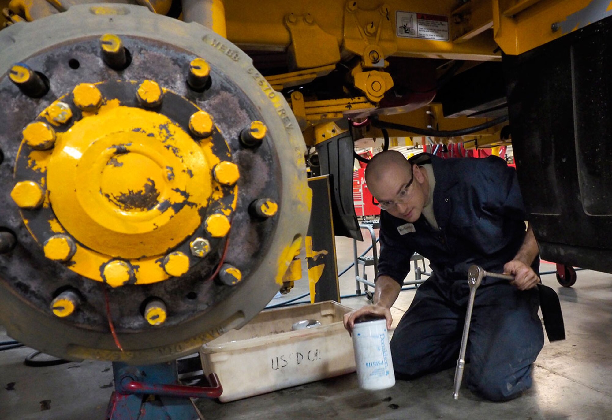 Diesel mechanic Airman 1st Class Brian Richmond, assigned to the 673d Logistics Readiness Squadron, a native of Pulaski, Wis., changes the fuel filter on a snow broom during annual rebuilding maintenance procedures on snow plows, and snow removal vehicles, Wednesday, July 8, 2015. The heavy equipment is used to clear the runways and roads on Joint Base Elmendorf-Richardson, Alaska, during the winter season. (U.S. Air Force photo/Justin Connaher)