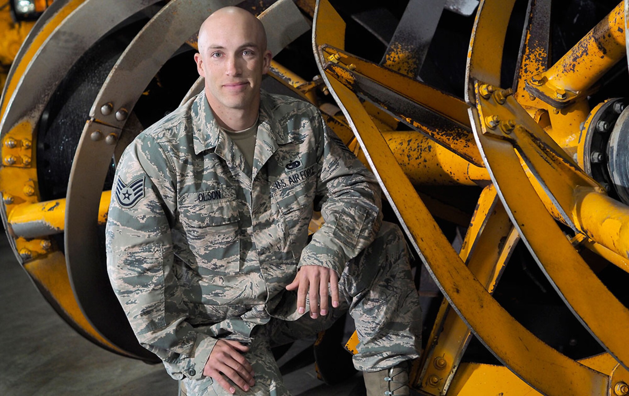 Air Force Staff Sgt. Justin Olson, a floor supervisor, assigned to the 673d Logistics Readiness Squadron, a native of Rochester, N.Y., poses for a photo during annual rebuilding maintenance procedures on snow plows, and snow removal vehicles, Wednesday, July 8, 2015. The heavy equipment is used to clear the runways and roads on Joint Base Elmendorf-Richardson, Alaska, during the winter season.(U.S. Air Force photo/Justin Connaher)