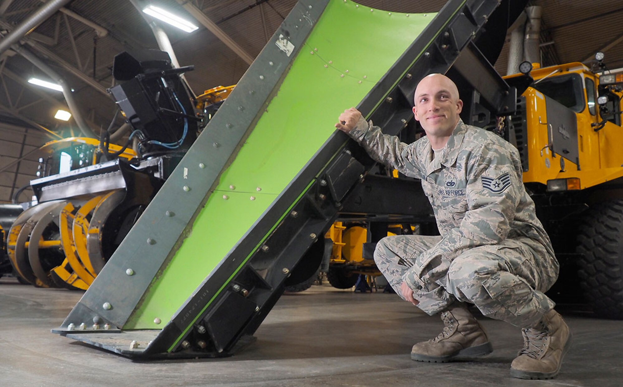 Air Force Staff Sgt. Justin Olson, a floor supervisor, assigned to the 673d Logistics Readiness Squadron, a native of Rochester, N.Y., poses for a photo during annual rebuilding maintainance proceedures on snow plows, and snow removal vehicles, Wednesday, July 8, 2015. The heavy equipment is used to clear the runways and roads on Joint Base Elmendorf-Richardson, Alaska, during the winter season.(U.S. Air Force photo/Justin Connaher)