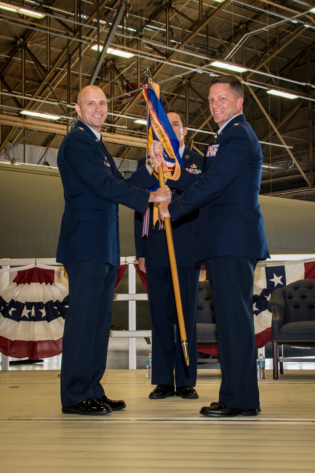 Lt. Col. David Pike, 92nd Operations Group deputy commander, gives the 92nd Operations Support Squadron guidon to Lt. Col. Matthew Coleman, 92nd OSS commander, during the 92nd OSS change of command ceremony July 9, 2015, at Fairchild Air Force Base, Wash. The change of command ceremony is an official, formal and brief ceremony that is the military's way of bestowing command responsibility of a unit from one officer to another. (U.S. Air Force photo/Staff Sgt. Benjamin W. Stratton)