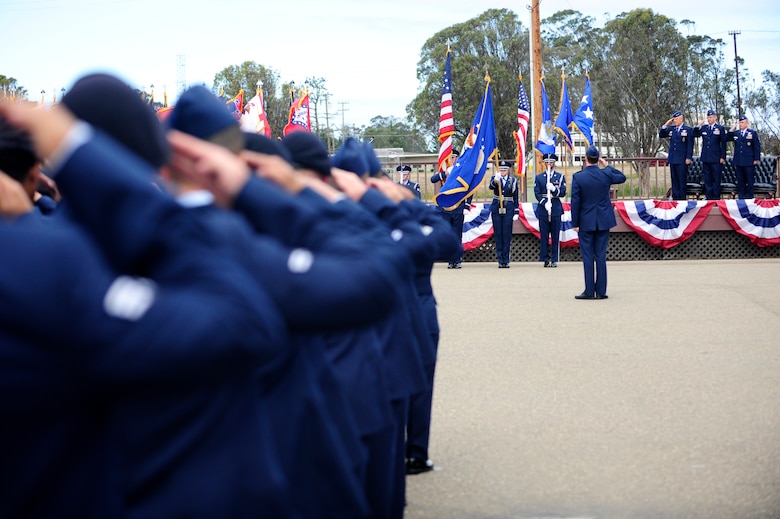 Vandenberg Airmen render a salute during the 30th Space Wing change of command ceremony, July 9, 2015, Vandenberg Air Force Base, Calif. Col. Keith Balts relinquished command of the 30th SW to Col. J. Christopher Moss. (U.S. Air Force photo by Staff Sgt. Jim Araos/Released)
