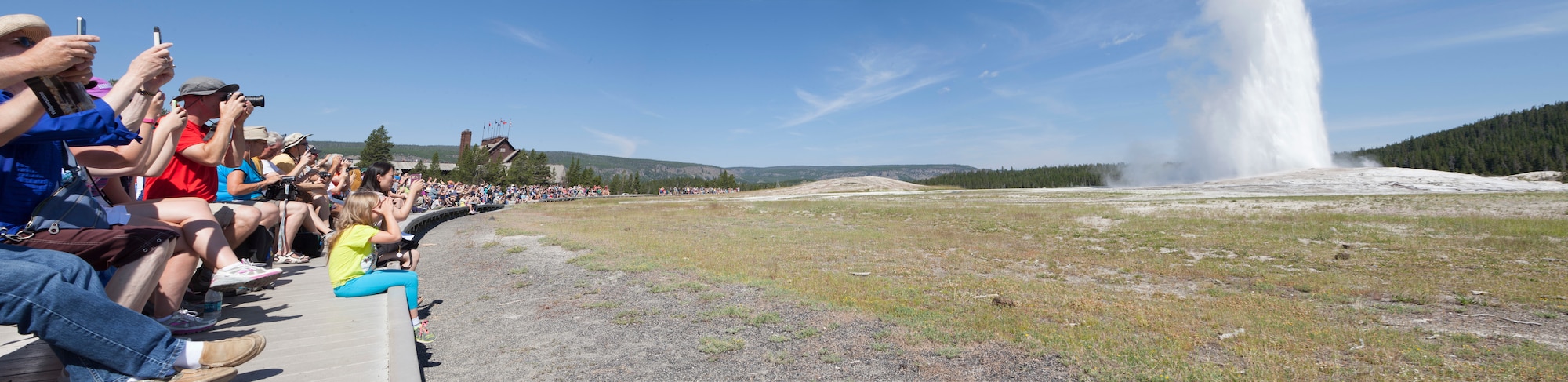 This photo panorama created from three separate images, depicts a crowd of spectators viewing the eruption of Old Faithful Geyser at Yellowstone National Park, Wyo., July 4, 2015. Airmen and civilians from F.E. Warren Air Force Base were on an Outdoor Recreation trip that explored the natural features of Yellowstone and Grand Teton National Park for the July 4th weekend. (U.S. Air Force photo illustration by Lan Kim)