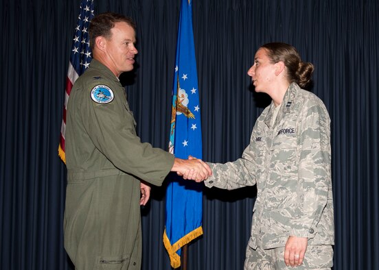 Col. Byron Anderson, 366th Fighter Wing vice commander, presents Capt. Judene Rohde, installation project officer of the campaign on base, with his commander’s coin for her hard work leading the Air Force Assistance Fund campaign at Mountain Home Air Force Base, Idaho, July 8, 2015. MHAFB was able to make 100 percent contact with all personnel on base this year. (U.S. Air Force photo by Airman 1st Class Jeremy L. Mosier)