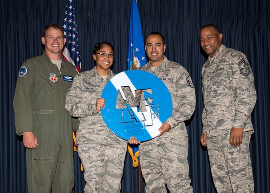 Col. Byron Anderson, 366th Fighter Wing vice commander, and Chief Master Sgt. David Brown, 366th FW command chief, present members of the 366th Medical Group with the large Blue and White Coin at Mountain Home Air Force Base, Idaho, July 8, 2015. The 366th Medical Group had the highest Air Force Assistance Fund participation rate on base. (U.S. Air Force photo by Airman 1st Class Jeremy L. Mosier)