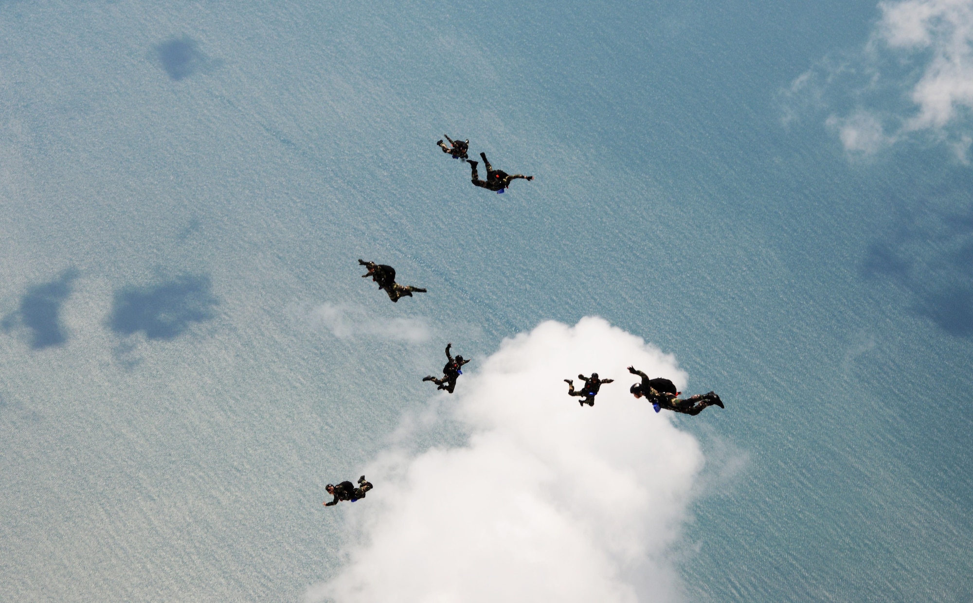 Members from the Royal Malaysian Air Force Pasukan Khas Udara jump from an MC-130J Commando II near Kuantan, Malaysia, June 8, 2015. The high-altitude low-opening jumps were conducted as part of Exercise Teak Mint, a multinational and bilateral exercise between the Royal Malaysian Air Force and the U.S. Air Force. (U.S. Air Force photo by Tech. Sgt. Kristine Dreyer) 