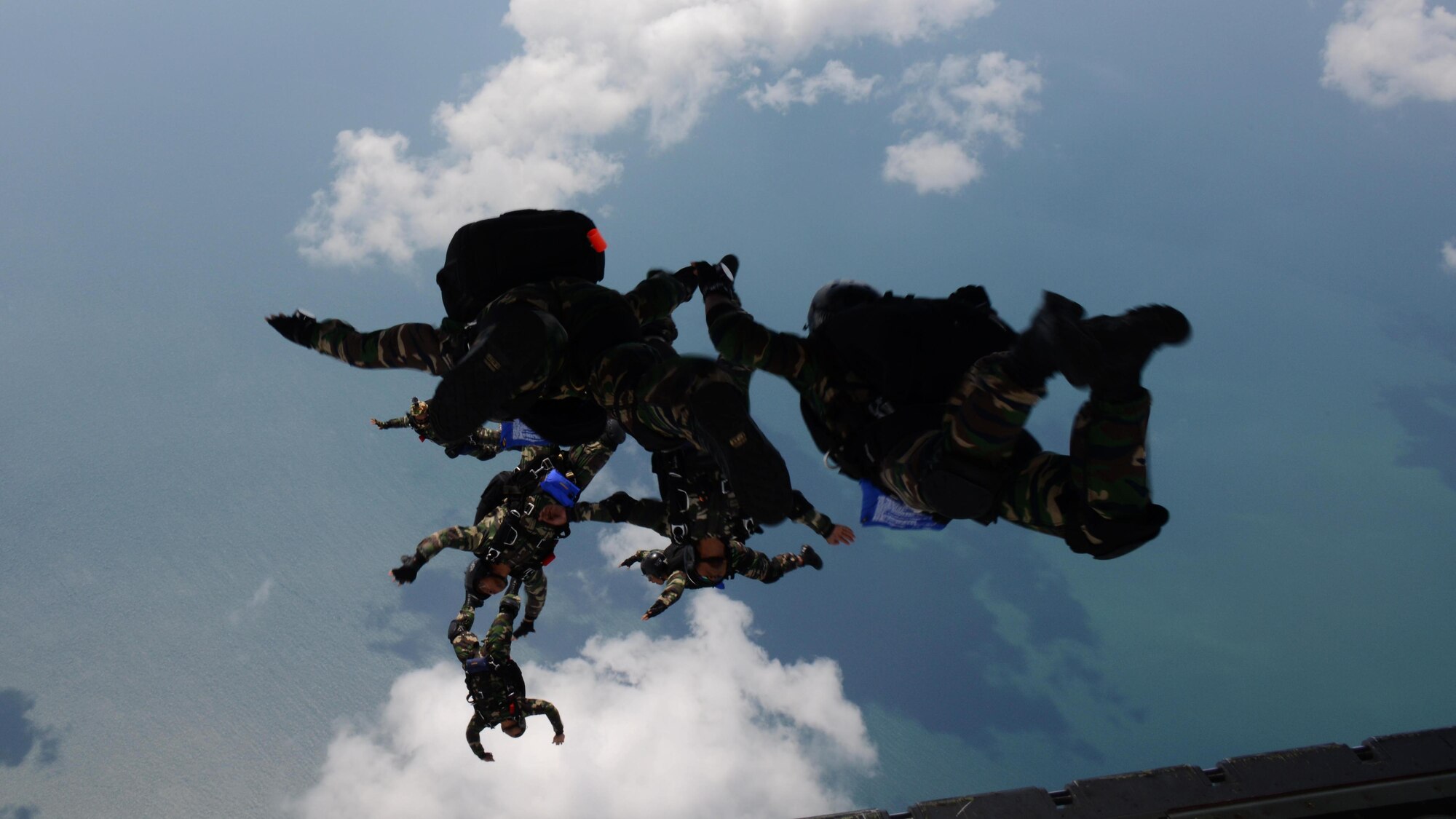 Royal Malaysian Air Force Pasukan Khas Udara jump from an MC-130J Commando II near Kuantan, Malaysia, June 8, 2015. The high-altitude low-opening jumps were conducted as part of Exercise Teak Mint, a multinational and bilateral exercise between the Royal Malaysian Air Force and the U.S. Air Force. (U.S. Air Force photo by Tech. Sgt. Kristine Dreyer) 