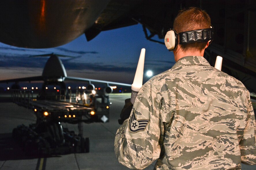 Staff Sgt. Andrew Sabatine, APEX student, Yokota AB, Japan, guides a 60K tunner aircraft loader July 7 at Travis Air Force Base, California, during hands-on APEX training. The 60K tunner is able to carry six pallets at a time.  (U.S. Air Force photo by Airman 1st Class Amber Carter)
