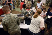 Members of Team Malmstrom participate in Multicultural Fair July 8, 2015, at Malmstrom Air Force Base, Mont. Information booths allowed fair-goers to sample food, play games and learn facts about the ten specific cultures. (U.S. Air Force photo/Chris Willis)