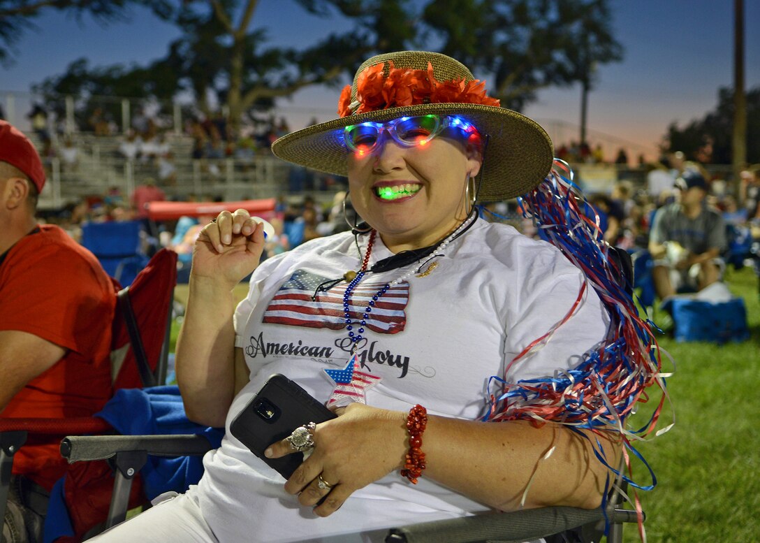 An attendee during the 2015 Freedom Fest exhibits her colorful patriotism prior to the national anthem and fireworks demonstration held July 4 at Wings and Roberts Fields. (U.S. Air Force photo by Jet Fabara)