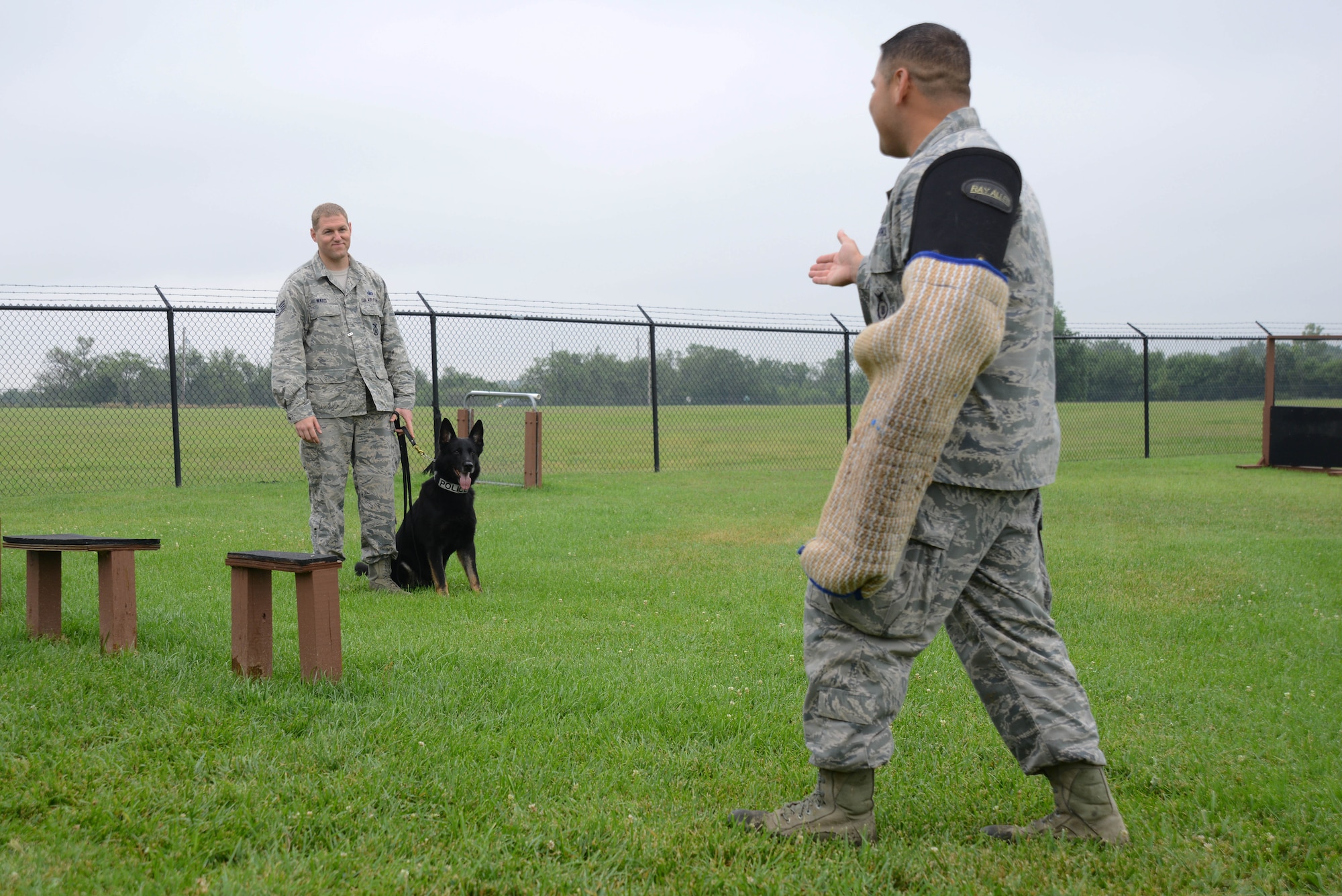 U.S. Air Force Academy cadets visit the 22nd Security Forces Squadron Military Working Dogs and their handlers, July 8, 2015, at McConnell Air Force Base, Kan. The cadets met with handlers, asked questions and watched a demonstration to explore the career field of a SFS officer. (U.S. Air Force photos by Airman 1st Class Christopher Thornbury)