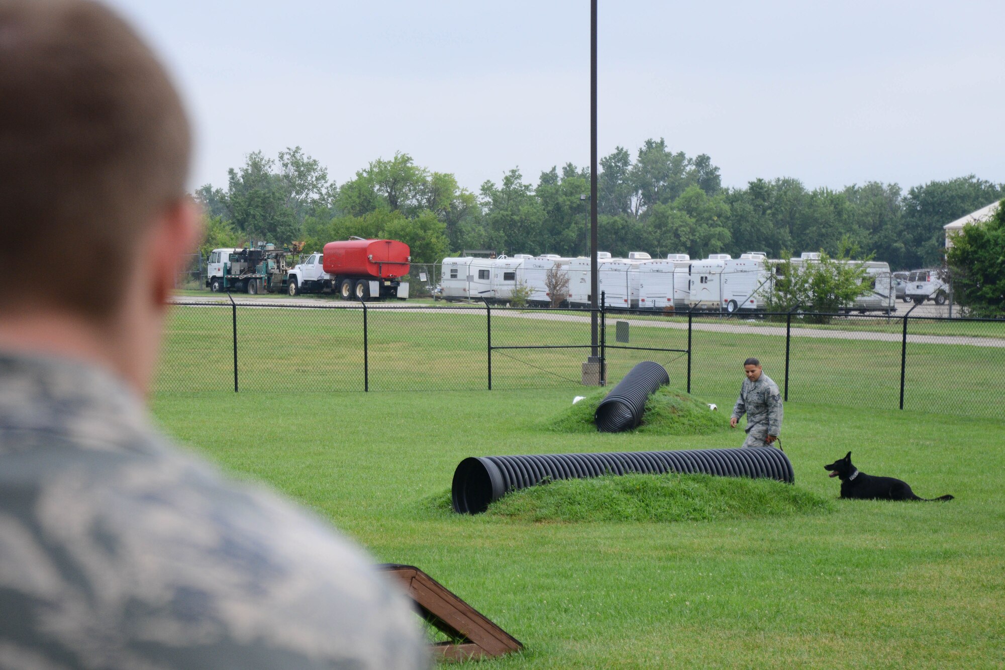 U.S. Air Force Academy cadets visit the 22nd Security Forces Squadron Military Working Dogs and their handlers, July 8, 2015, at McConnell Air Force Base, Kan. The cadets met with handlers, asked questions and watched a demonstration to explore the career field of a SFS officer. (U.S. Air Force photos by Airman 1st Class Christopher Thornbury)