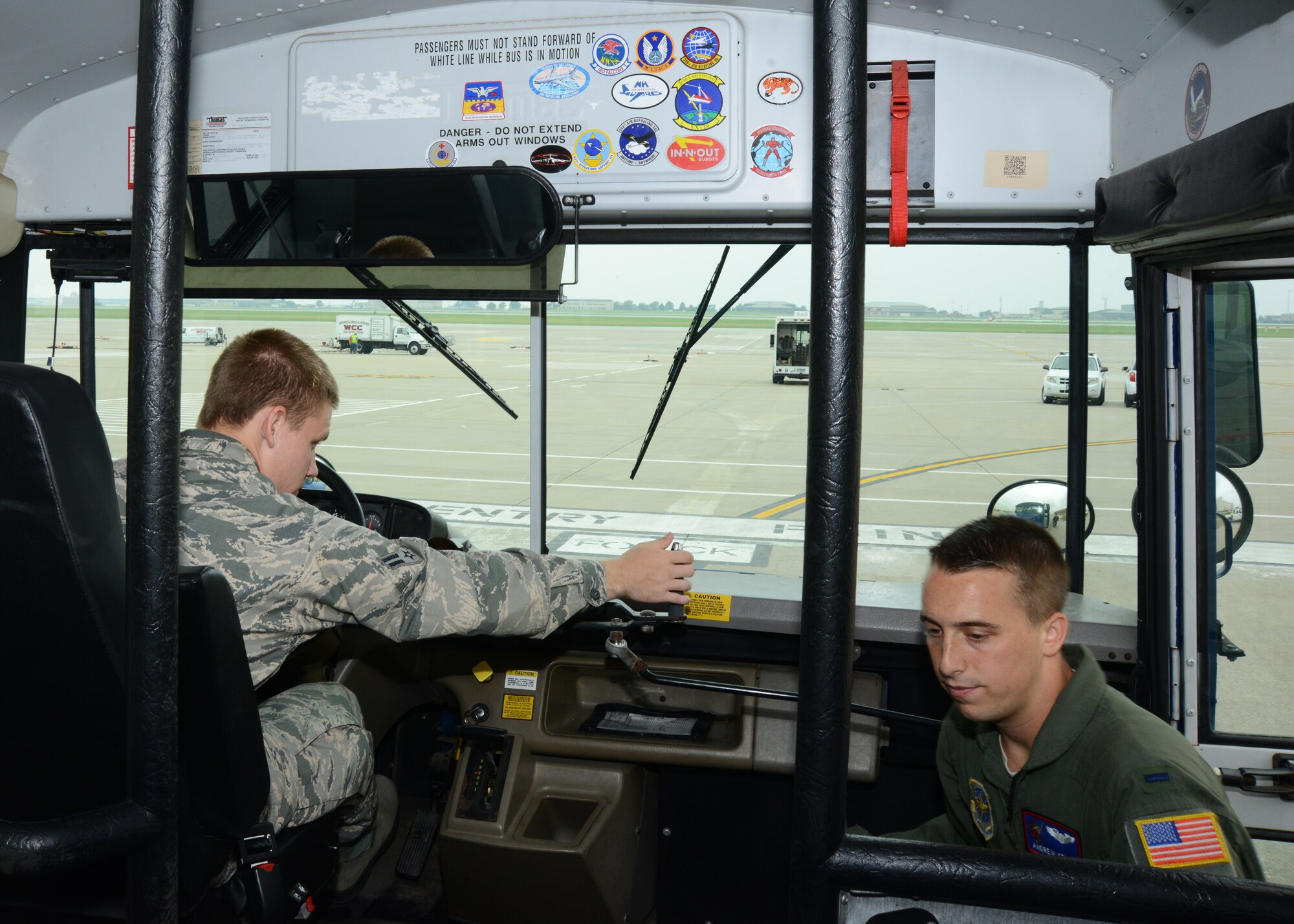 A KC-135 Stratotanker pilot boards a 22nd Logistics Readiness Squadron bus after a tire check, July 7, 2015, McConnell Air Force Base, Kan. Before a vehicle enters the flightline, a tire check is completed to ensure the flightline is not damaged by debris and rocks while transporting aircrews to their aircraft. (U.S. Air Force photo by Airman 1st Class Christopher Thornbury)