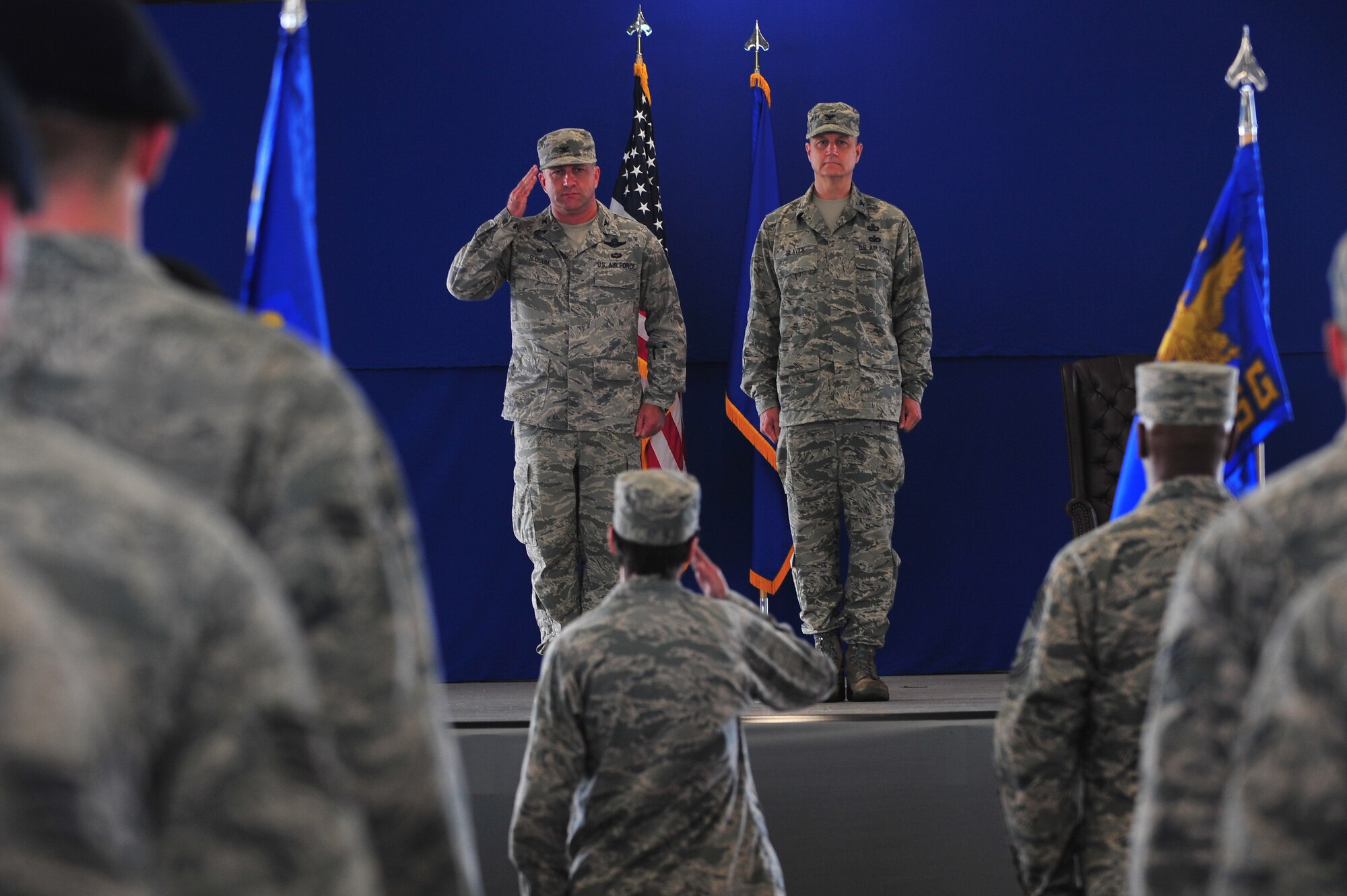 Lt. Col. Denise McAllister, bottom middle, 4th Logistics Readiness Squadron commander, presents the command to Col. Mark Slocum, middle left, 4th Fighter Wing commander, during the 4th Mission Support Group assumption of command ceremony, July 8, 2015, at Seymour Johnson Air Force Base, North Carolina. The 4th MSG has approximately 1,550 personnel assigned to the unit. (U.S. Air Force photo/Senior Airman John Nieves Camacho)