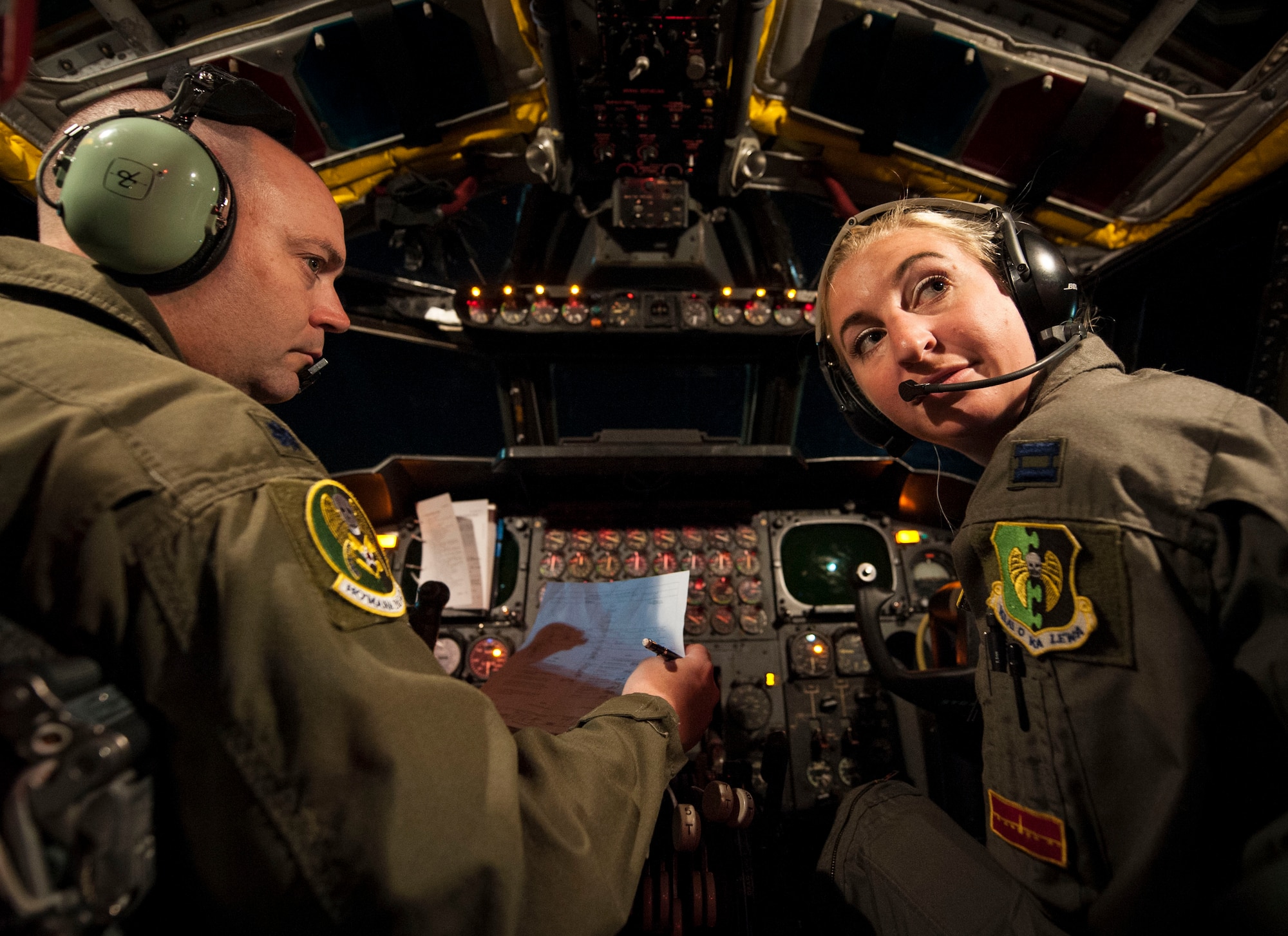 Lt. Col. Monte Wiley, 69th Bomb Squadron pilot (left), completes pre-flight
check as Capt. Kristin Nelson, 23rd BS pilot (right), listens to input from
other crew members inside their B-52H Stratofortress at Minot Air Force
Base, N.D., July 9, 2015. Wiley and Nelson piloted one of two B-52H
Stratofortresses participating in a 16-hour mission to support an air show
in Rio Negro, Colombia. (U.S. Air Force photo/Senior Airman Stephanie
Morris)

