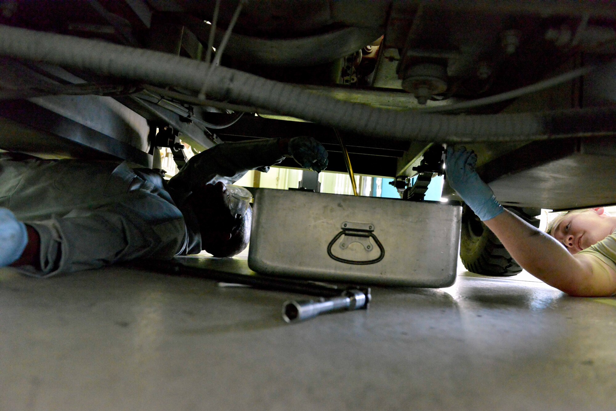 Senior Airman Michael Feagin, 39th Maintenance Squadron Aerospace Ground Equipment journeyman, instructs Chief Master Sgt. Vegas Clark, 39th Air Base Wing command chief, on the proper way to change a generator’s oil during a unit visit July 2, 2015, at Incirlik Air Base, Turkey. Clark met with Airmen of the 39th MXS as part of the commander’s Out Connecting with Airmen Program. (U.S. Air Force photo by Senior Airman Michael Battles/Released) 