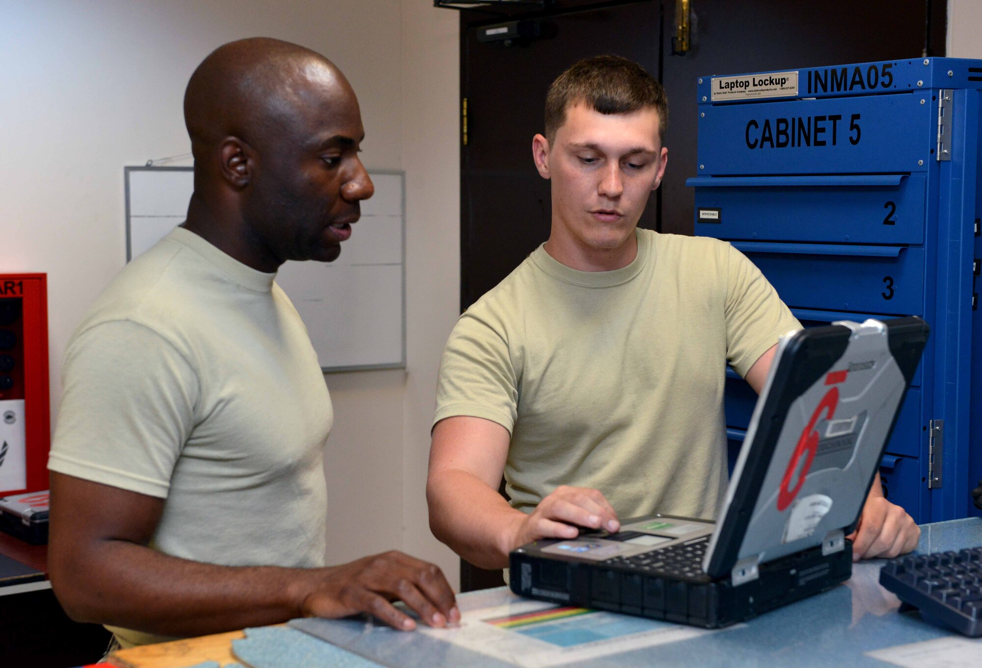 Senior Airman Michael Feagin, 39th Maintenance Squadron Aerospace Ground Equipment journeyman, teaches Chief Master Sgt. Vegas Clark, 39th Air Base Wing command chief, the proper way to check out a toolbox during a unit visit July 2, 2015, at Incirlik Air Base, Turkey. During the visit, Clark coined Feagin for his dedication to the mission and Incirlik. (U.S. Air Force photo by Senior Airman Michael Battles/Released)