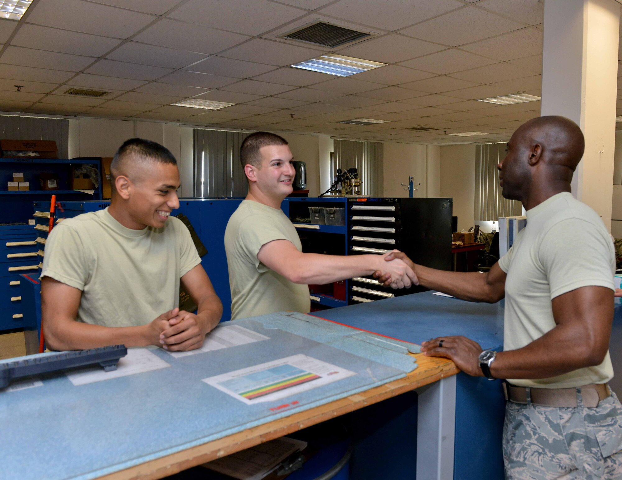 Chief Master Sgt. Vegas Clark, 39th Air Base Wing command chief, speaks with Senior Airman Daniel Clayton and Airman 1st Class Jesse Hernandez, both 39th Maintenance Squadron Aerospace Ground Equipment journeymen, during a unit visit July 2, 2015, at Incirlik Air Base, Turkey. Each week, 39th ABW leadership meets with Airmen from different units and offices across Team Incirlik to better understand their jobs. (U.S. Air Force photo by Senior Airman Michael Battles/Released)