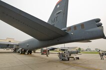 Airmen from the 5th Aircraft Maintenance Squadron use a MHU-83 “Jammer” to move the second of two inert AGM-158 missiles during the Load Crew of the Quarter competition at Minot Air Force Base, N.D., July 1, 2015.   The first four-man team completed the competition with a time of about 1 hour, 5 minutes. (U.S. Air Force photo/ Airman 1st Class Justin T. Armstrong)