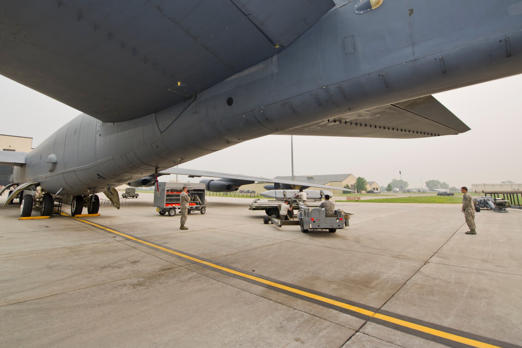 Airmen from the 5th Aircraft Maintenance Squadron use a MHU-83 “Jammer” to move the second of two inert AGM-158 missiles during the Load Crew of the Quarter competition at Minot Air Force Base, N.D., July 1, 2015.   The first four-man team completed the competition with a time of about 1 hour, 5 minutes. (U.S. Air Force photo/ Airman 1st Class Justin T. Armstrong)