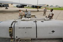 Airmen from the 5th Aircraft Maintenance Squadron prepare to move the second of two inert AGM-158 missiles during the Load Crew of the Quarter competition at Minot Air Force Base, N.D., July 1, 2015.   The first four-man team completed the competition with a time of about 1 hour, 5 minutes. (U.S. Air Force photo/ Airman 1st Class Justin T. Armstrong)