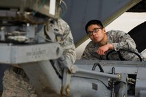 Airman 1st Class Ryandolph Alquetra, a 5th Aircraft Maintenance Squadron four man, positions a MHU-83 “Jammer” under the bomb rack of a B-52H Stratofortress during the Load Crew of the Quarter competition at Minot Air Force Base, N.D., July 1, 2015. Of the Airmen that make up the load crew, the four man is tasked with driving the MHU-83. (U.S. Air Force photo/ Airman 1st Class Justin T. Armstrong)