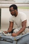 Staff Sgt. Demeterius White, a 5th Aircraft Maintenance Squadron load crew chief, inspects a MHU-83 “Jammer” carrying an AGM-158 missile during the Load Crew of the Quarter competition at Minot Air Force Base, N.D., July 1, 2015. The crews were timed on their ability to load two AGM-158s onto a B-52H Stratofortress. (U.S. Air Force photo/ Airman 1st Class Justin T. Armstrong)