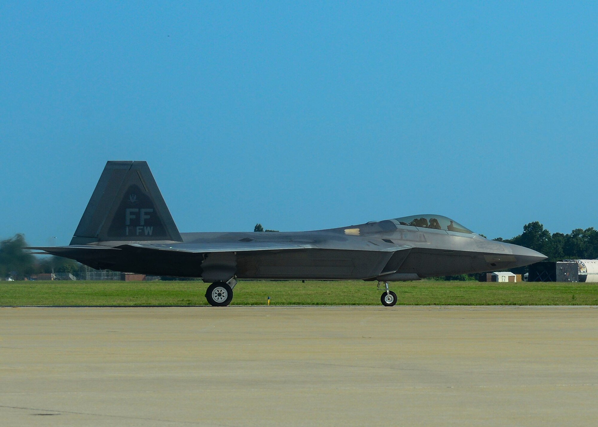 An F-22A Raptor prepares to take off for the fini flight of Brig. Gen. Kevin Huyck, 1st Fighter Wing commander, at Langley Air Force Base, Va., July 7, 2015. During his time as the commander Huyck was responsible for the worldwide rapid deployment and employment of F-22A air dominance fighters in support of combatant commander tasking’s. (U.S. Air Force photo by Senior Airman Kimberly Nagle/Released)
