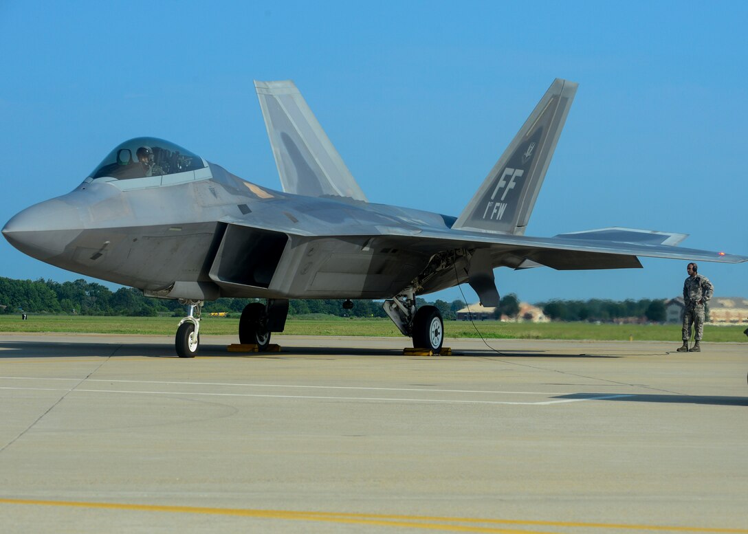 U.S. Air Force Senior Airman Ismael Debarros, 94th Fighter Squadron crew chief, checks the F-22A Raptor of Brig. Gen. Kevin Huyck, 1st Fighter Wing commander, before the start of his fini flight at Langley Air Force Base, Va., July 7, 2015. Ismael conducted an in-depth check of the F-22A Raptor before Huyck took off for his fini flight as the commander. (U.S. Air Force photo by Senior Airman Kimberly Nagle/Released)
