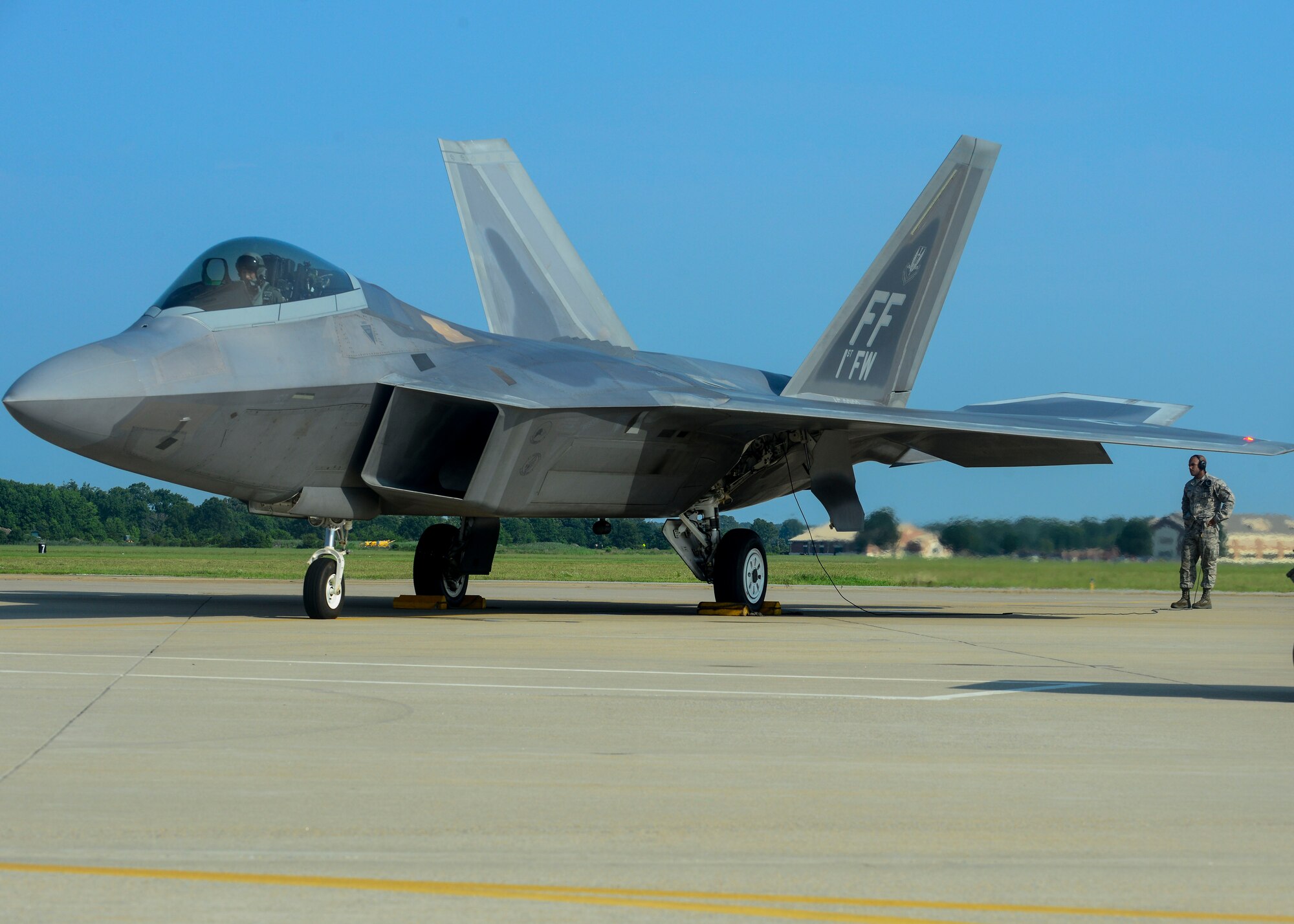 U.S. Air Force Senior Airman Ismael Debarros, 94th Fighter Squadron crew chief, checks the F-22A Raptor of Brig. Gen. Kevin Huyck, 1st Fighter Wing commander, before the start of his fini flight at Langley Air Force Base, Va., July 7, 2015. Ismael conducted an in-depth check of the F-22A Raptor before Huyck took off for his fini flight as the commander. (U.S. Air Force photo by Senior Airman Kimberly Nagle/Released)