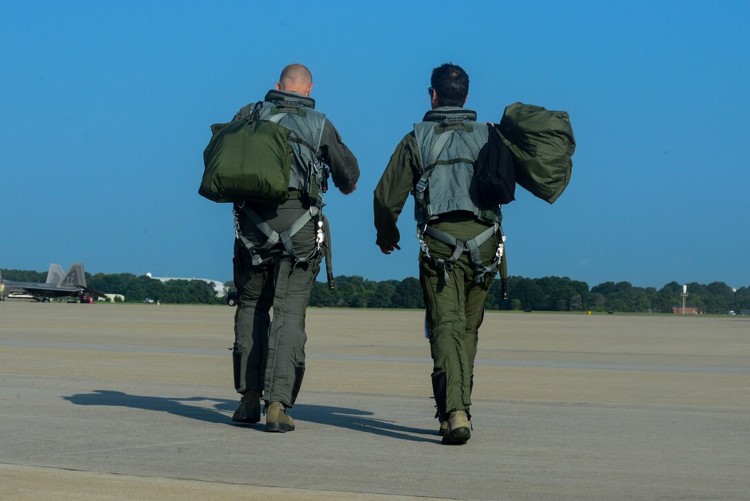 U.S. Air Force Brig. Gen. Kevin Huyck, 1st Fighter Wing commander, left, and Col. Jonathan Letsinger, 1st FW vice commander, walk onto the flight line at Langley Air Force Base, Va., July 7, 2015. The two took part in Huyck’s fini flight, used to signify the completion of his time with the 1st FW. (U.S. Air Force photo by Senior Airman Kimberly Nagle/Released)  