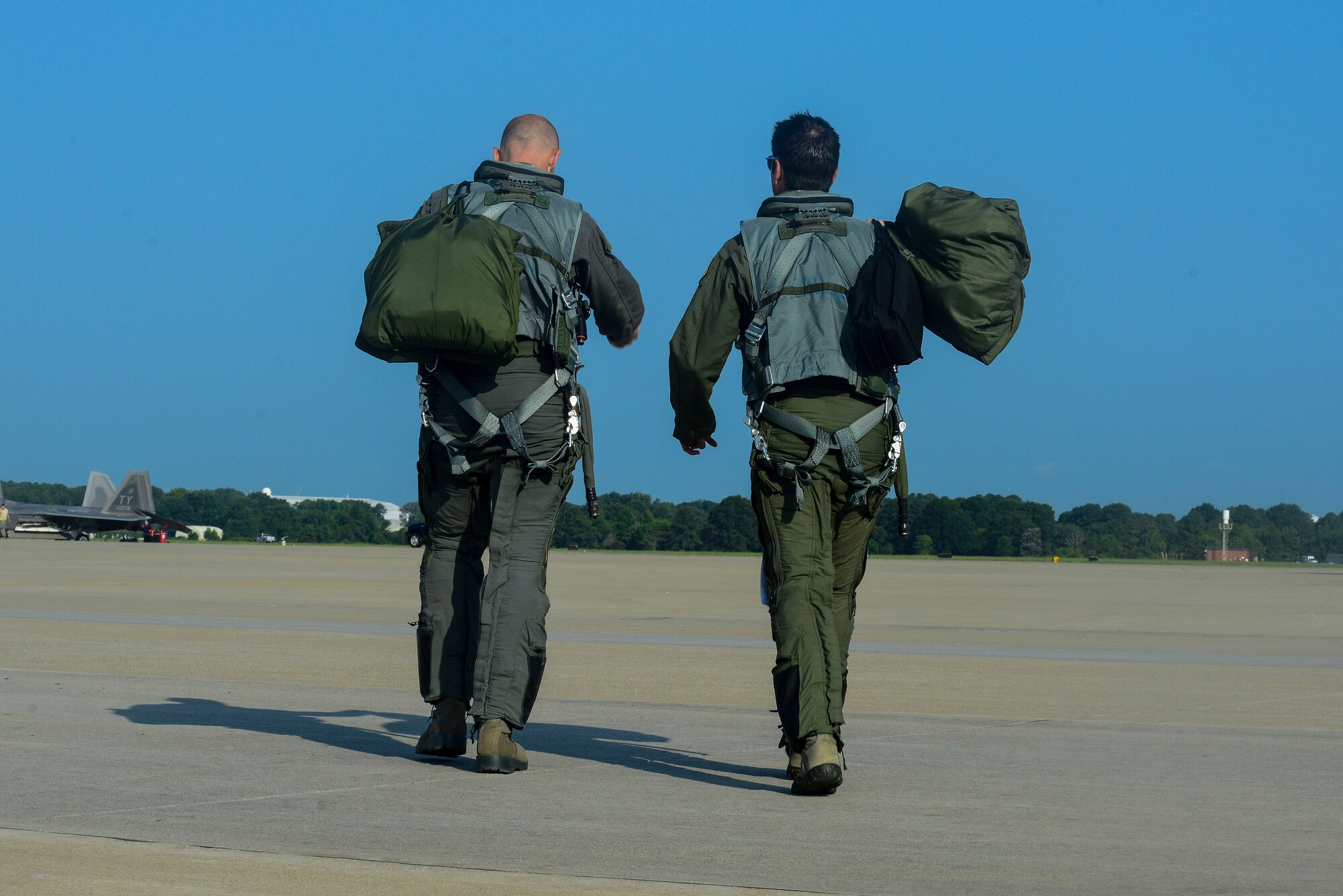 U.S. Air Force Brig. Gen. Kevin Huyck, 1st Fighter Wing commander, left, and Col. Jonathan Letsinger, 1st FW vice commander, walk onto the flight line at Langley Air Force Base, Va., July 7, 2015. The two took part in Huyck’s fini flight, used to signify the completion of his time with the 1st FW. (U.S. Air Force photo by Senior Airman Kimberly Nagle/Released)  